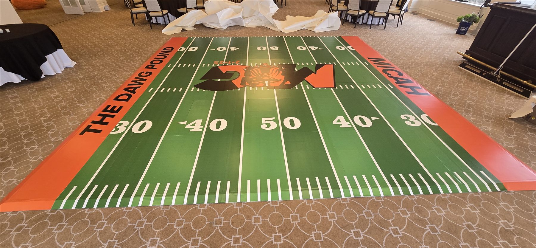 Custom-printed football field dance floor by Adicora